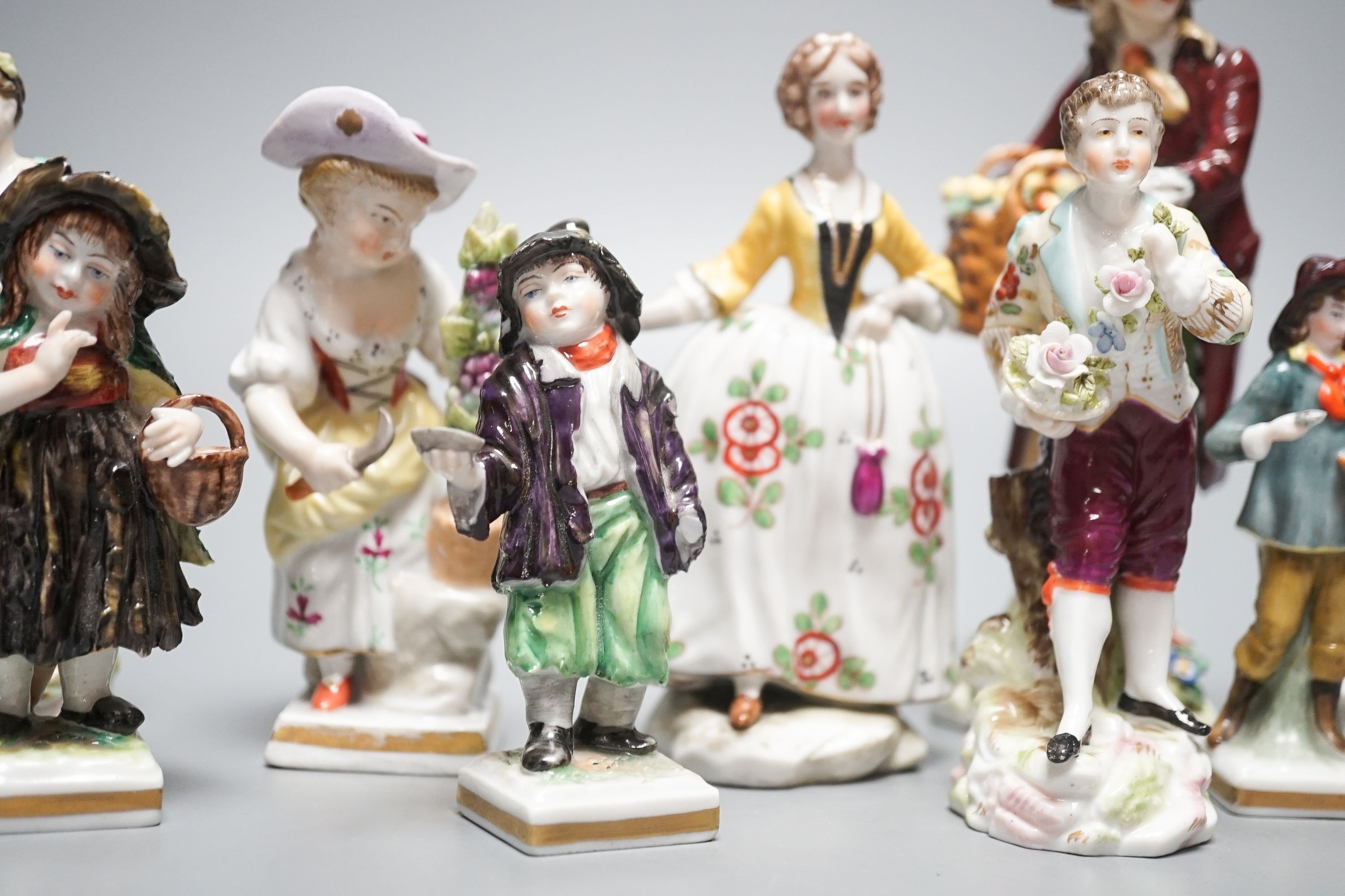 A collection of German porcelain figures, two by Sitzendorf, tallest 15.5 cm